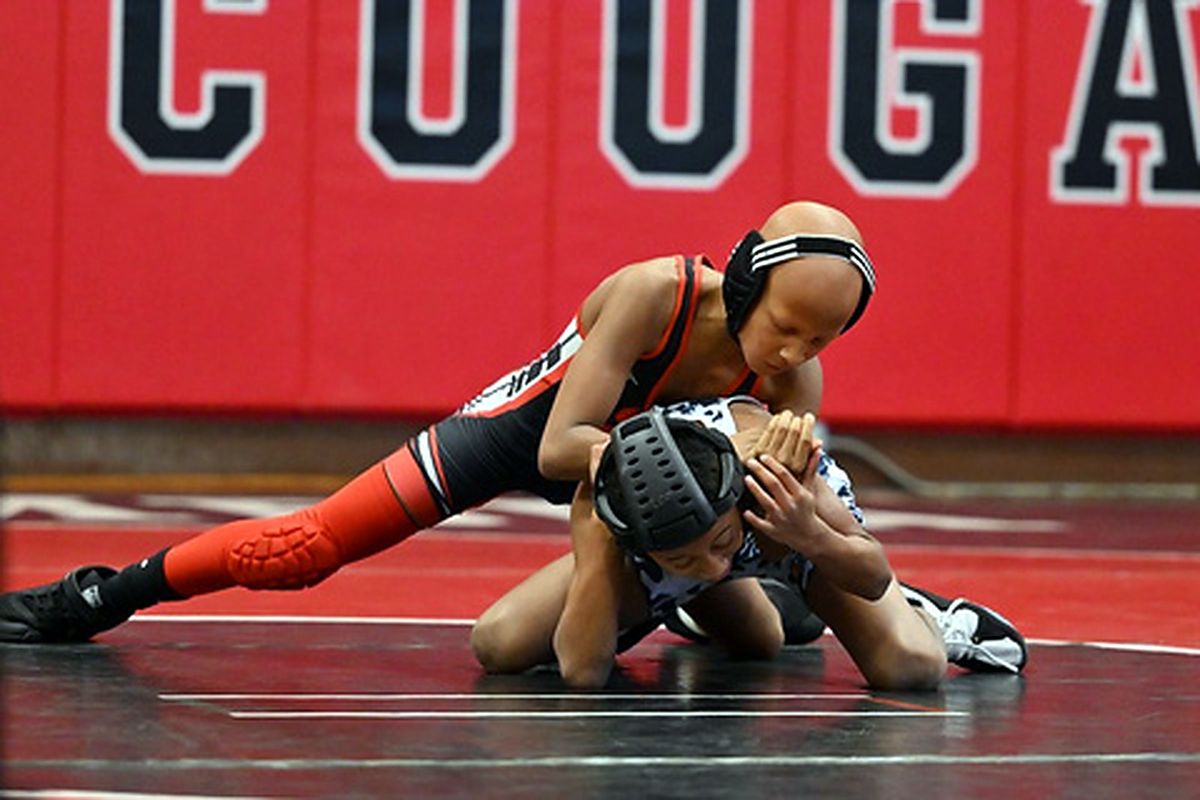 An MSO girl wrestler working from the top position during a match.