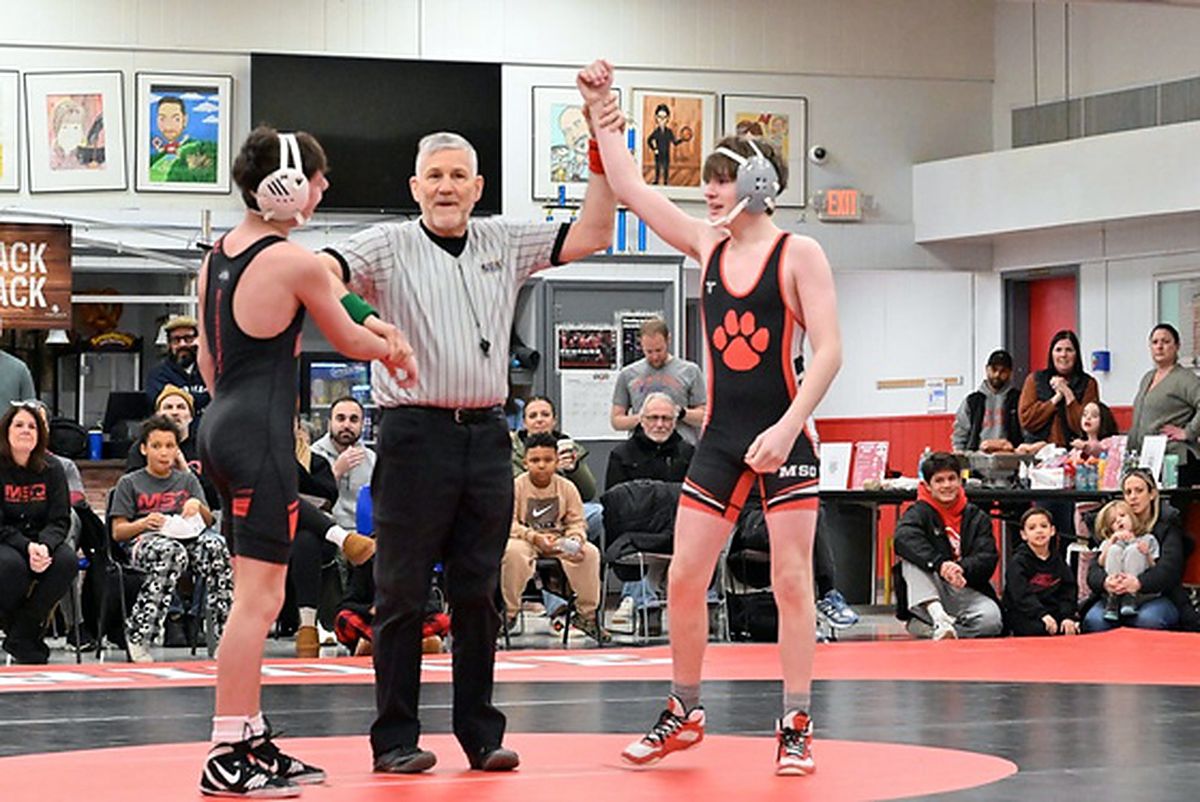 A referee raising the hand of an MSO wrestler after a win.