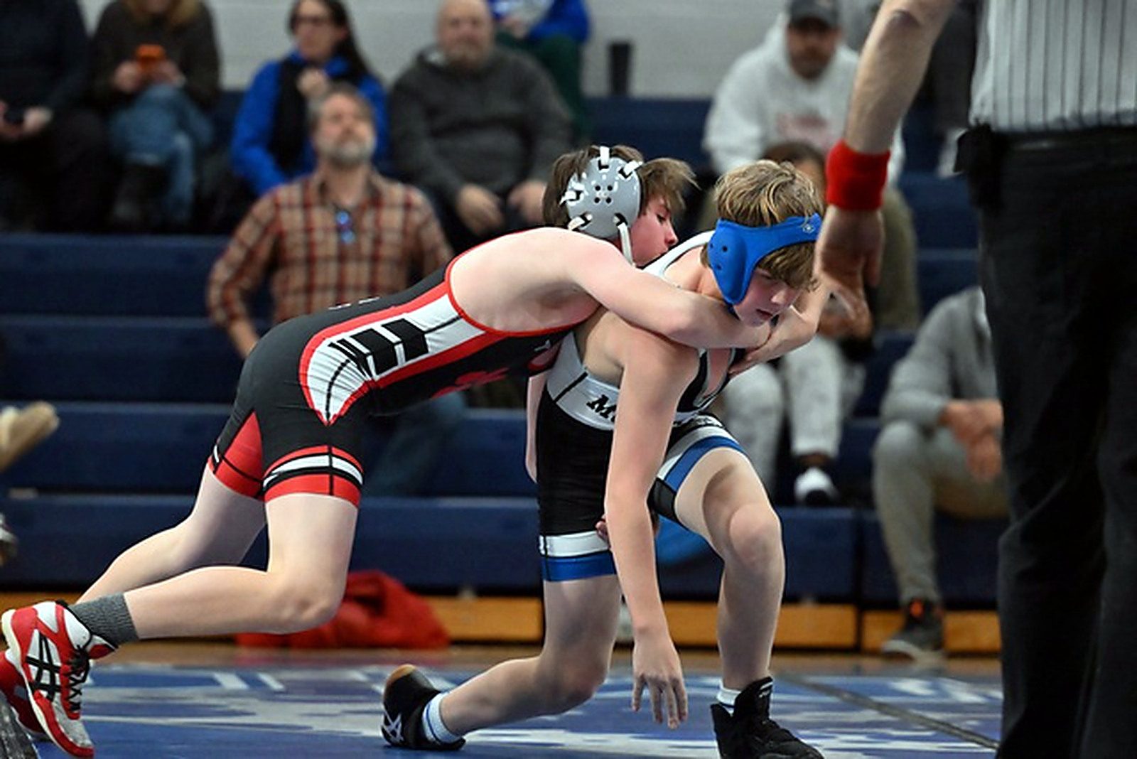 An MSO wrestler driving in for a takedown during a match.