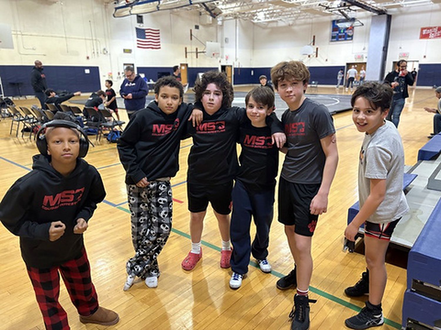 Six MSO teammates in team gear at a tournament.